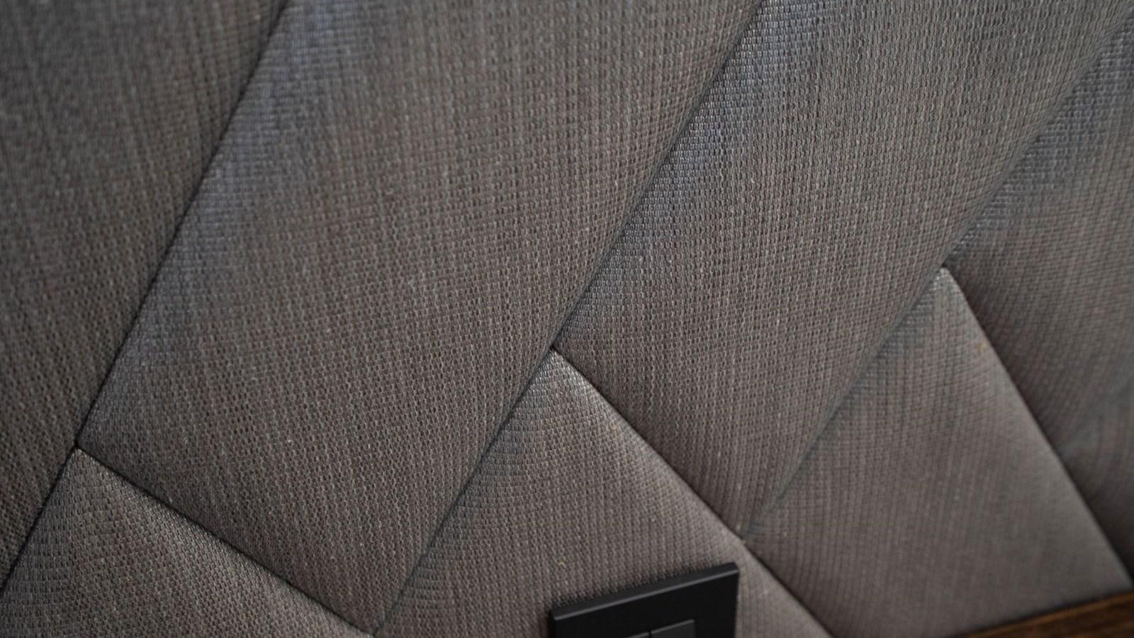 a close-up of a grey couch aboard PREDATOR 74 XPS Yacht for Sale