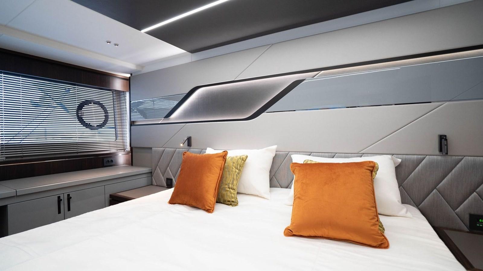 a bed with pillows aboard PREDATOR 74 XPS Yacht for Sale