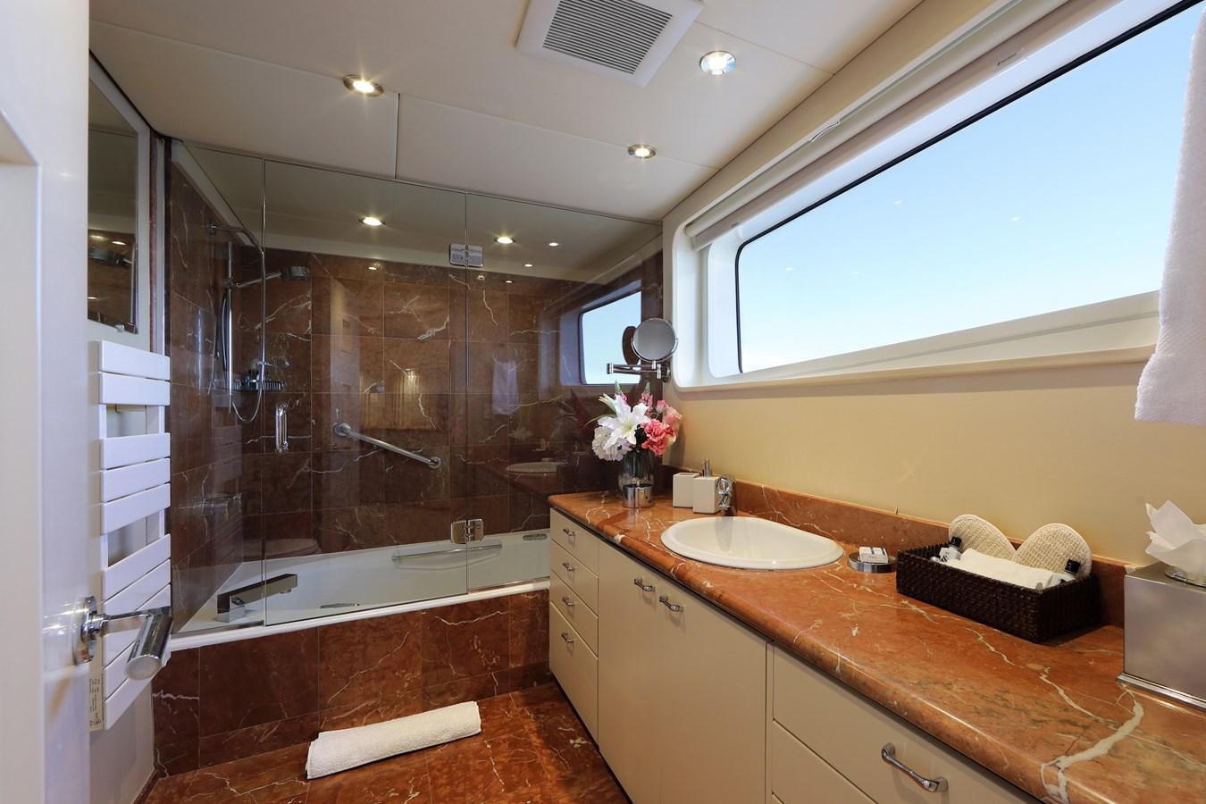a bathroom with a large glass shower aboard L'ALBATROS Yacht for Charter