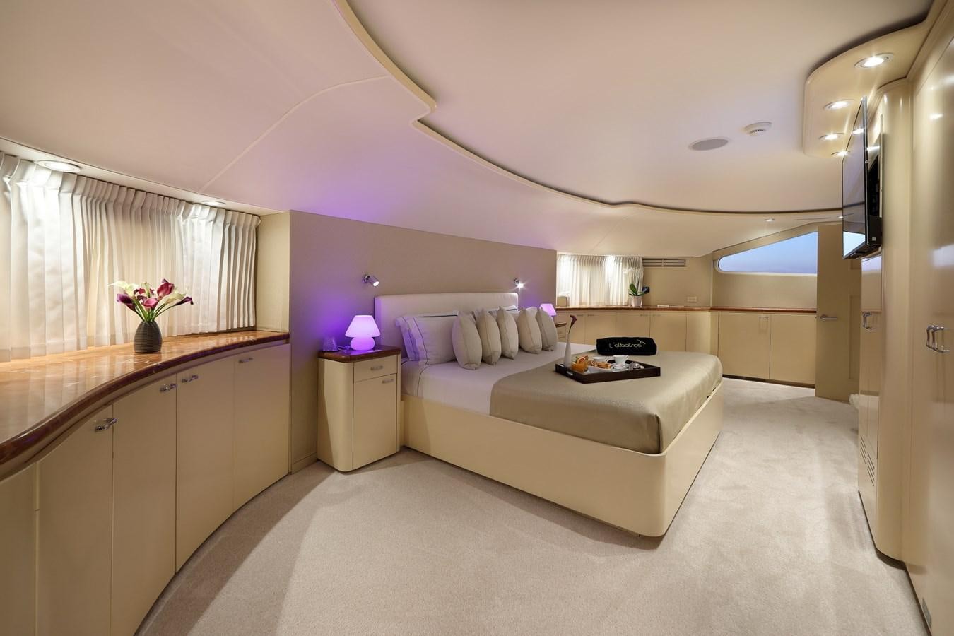 a bedroom with a bed and a desk aboard L'ALBATROS Yacht for Charter