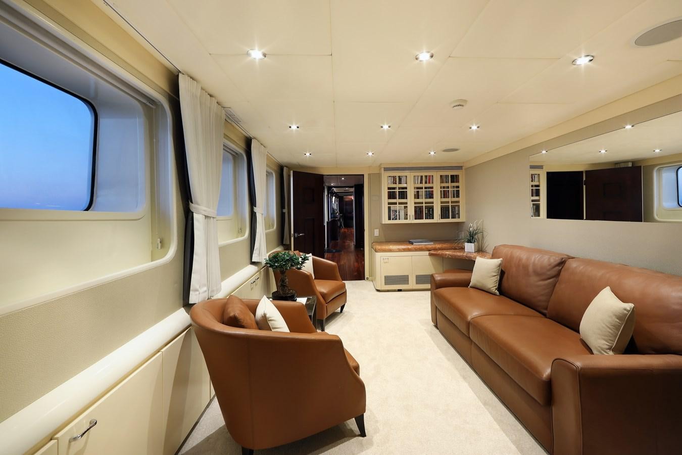 a living room with a couch and a television aboard L'ALBATROS Yacht for Charter