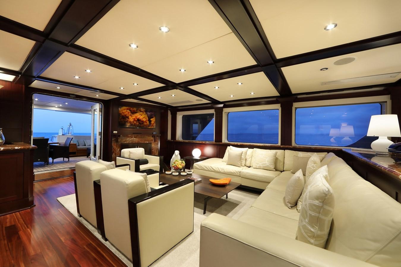 a living room with a large window aboard L'ALBATROS Yacht for Charter