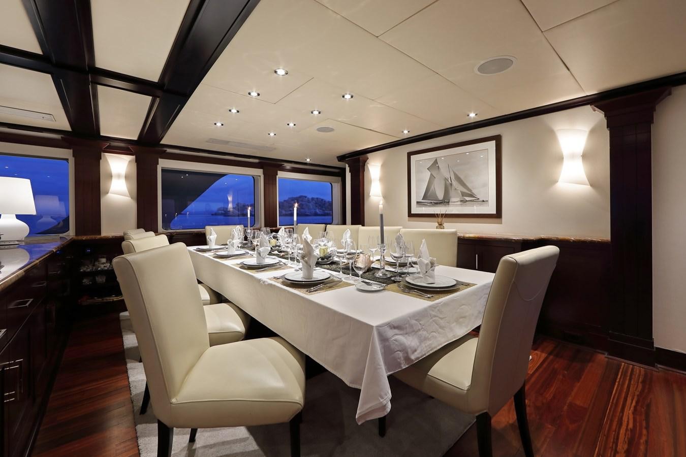 a table with chairs and a television aboard L'ALBATROS Yacht for Charter
