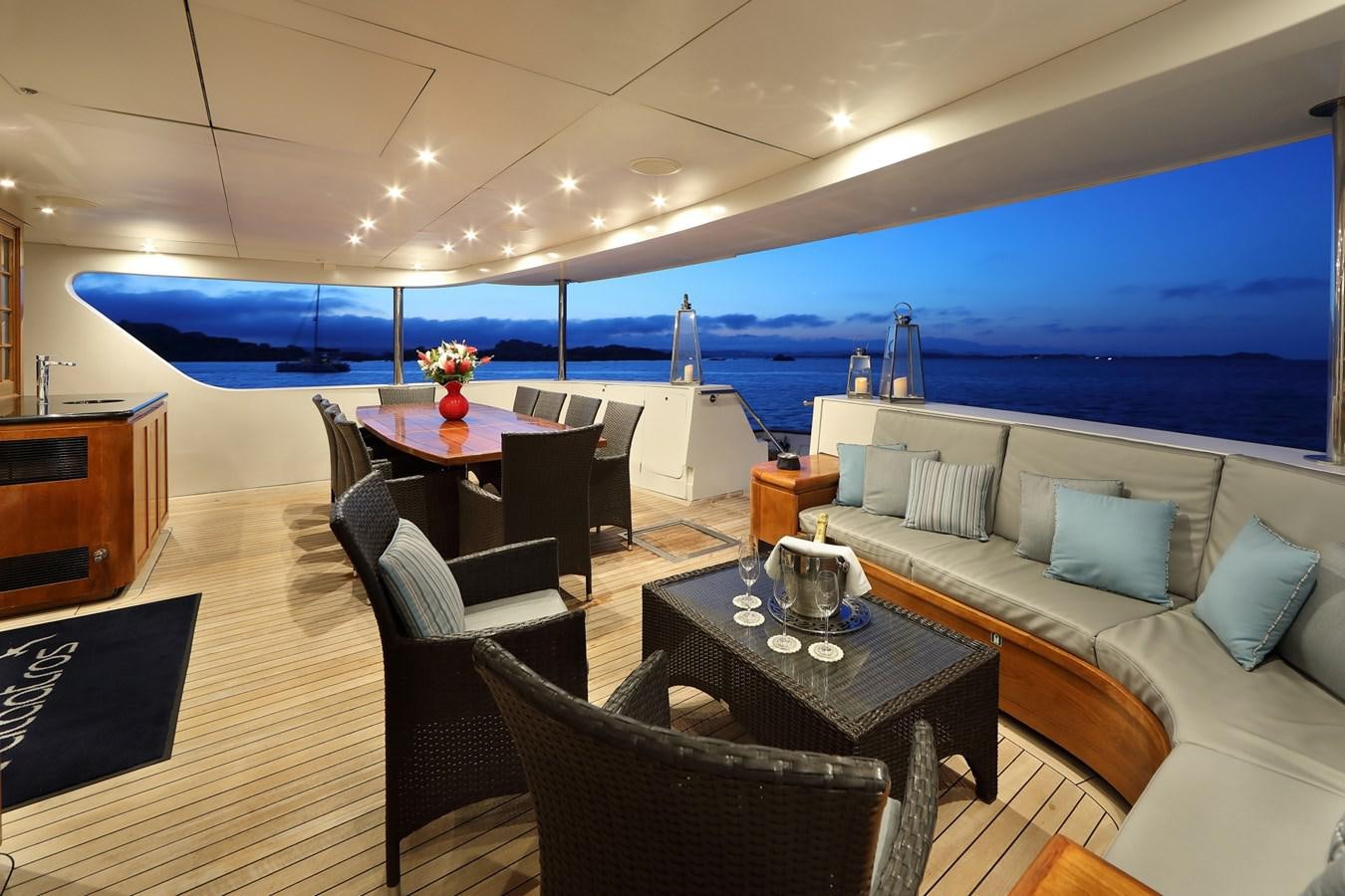 a room with a couch and a table and chairs aboard L'ALBATROS Yacht for Charter