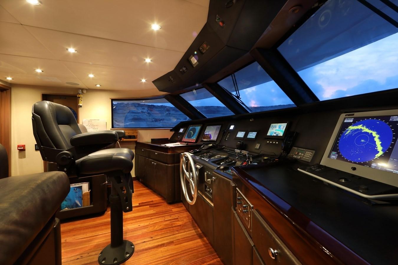 a room with a desk and chairs aboard L'ALBATROS Yacht for Charter