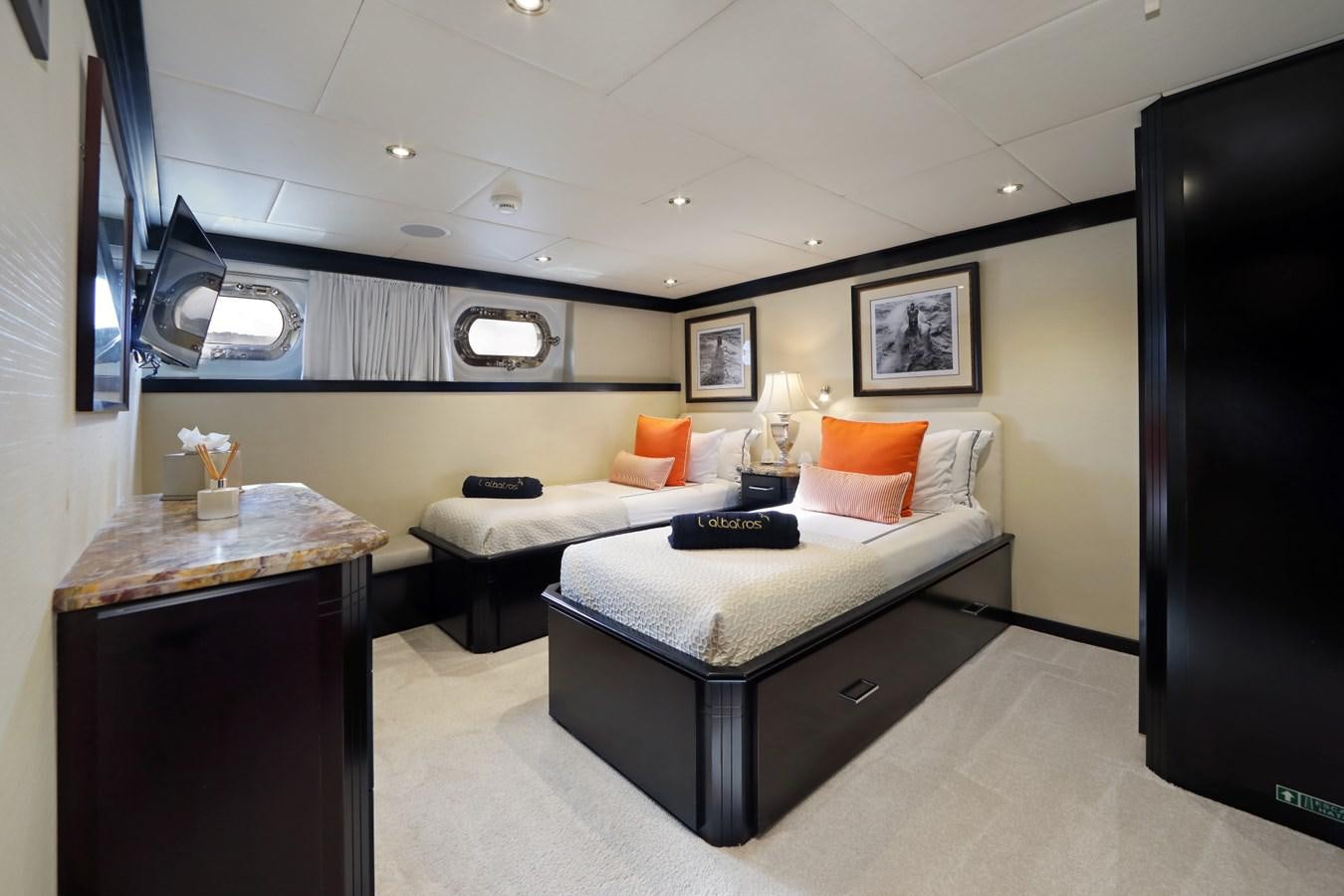 a room with a bed and a desk aboard L'ALBATROS Yacht for Charter
