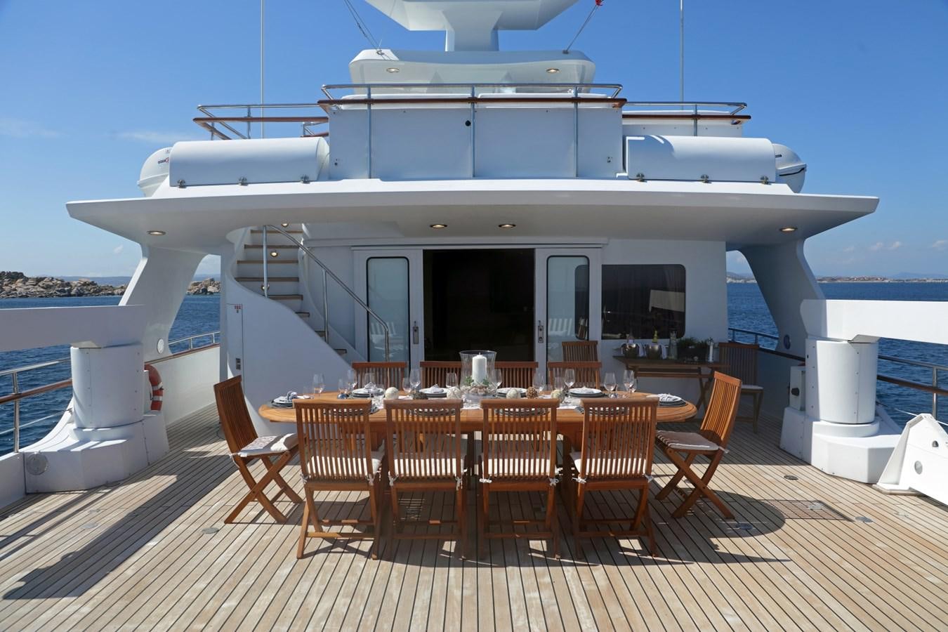 a large white boat with chairs around it aboard L'ALBATROS Yacht for Charter
