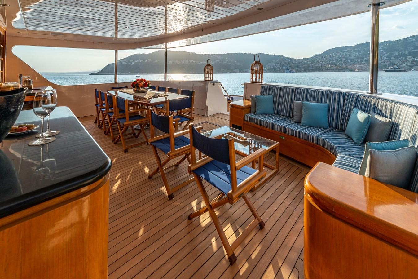 a patio with a couch and a table and chairs aboard L'ALBATROS Yacht for Sale