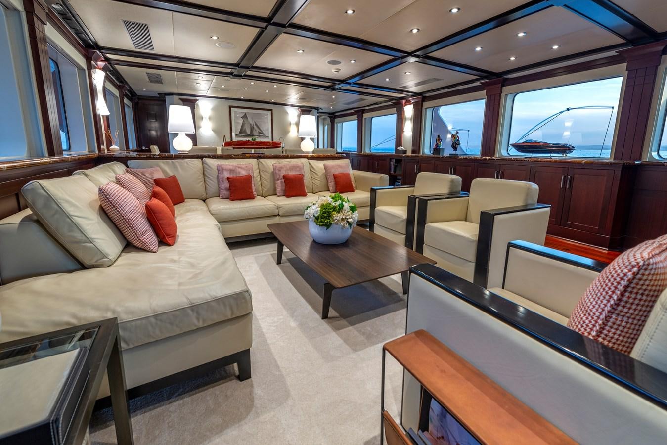 a room with couches and a table aboard L'ALBATROS Yacht for Sale