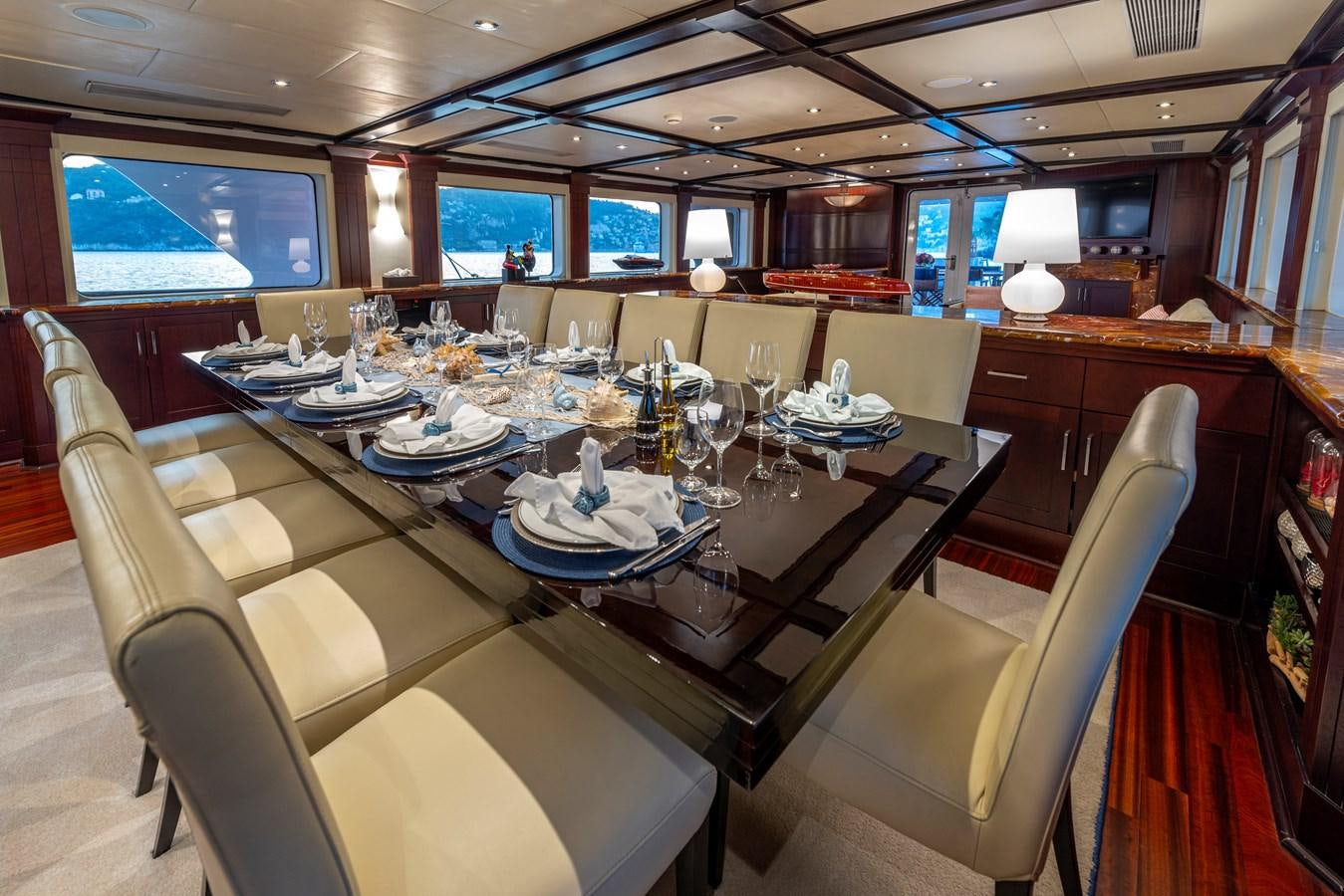 a large dining room with a large table and chairs aboard L'ALBATROS Yacht for Sale