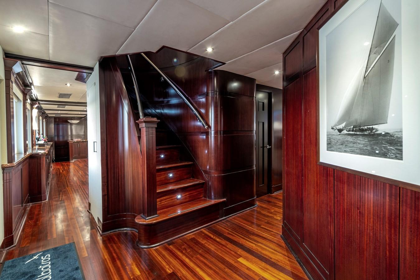 a wood staircase in a building aboard L'ALBATROS Yacht for Sale
