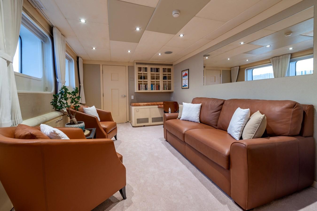 a living room with a couch and a table aboard L'ALBATROS Yacht for Sale