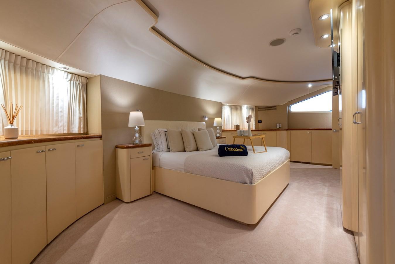 a bedroom with a bed and a desk aboard L'ALBATROS Yacht for Sale