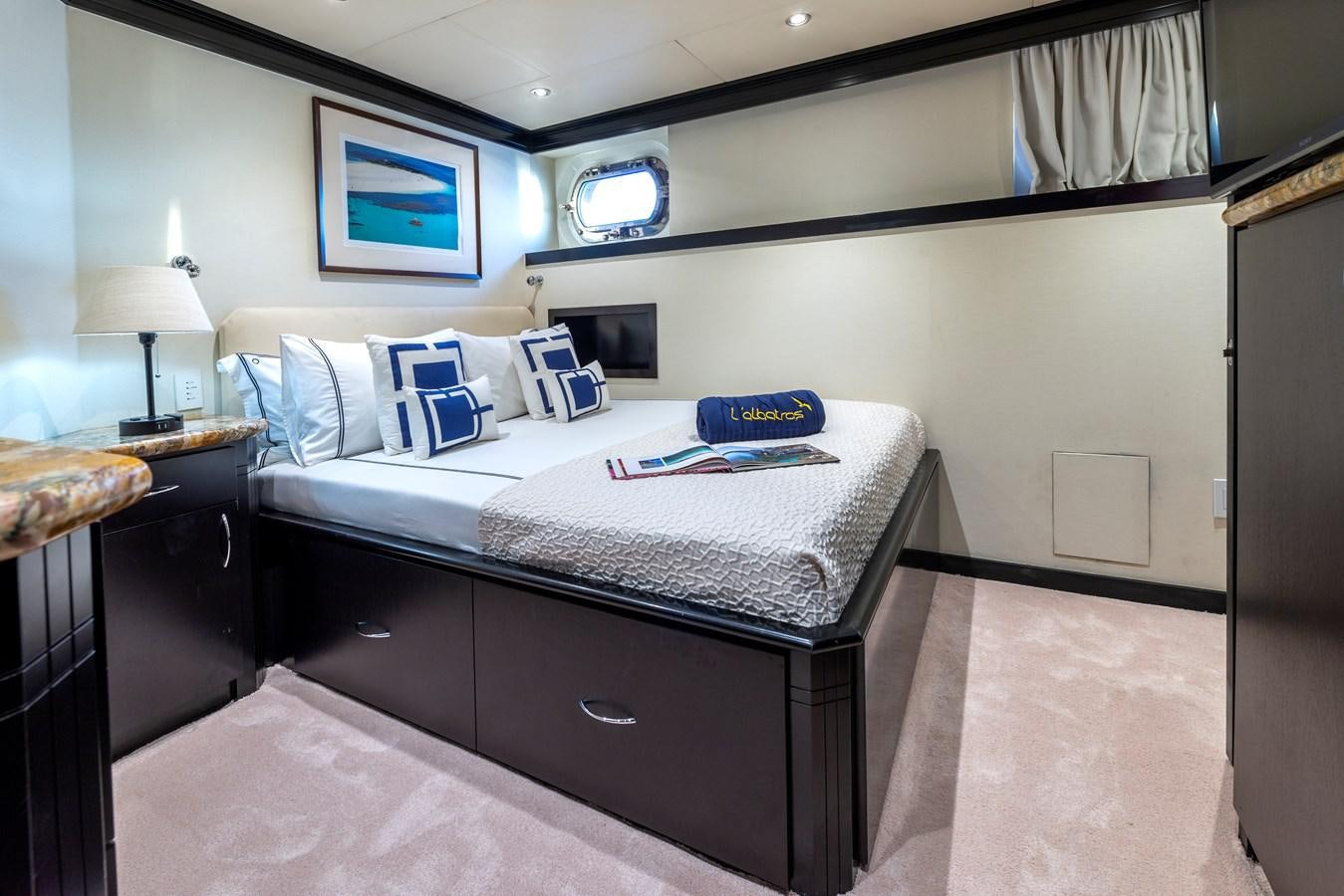 a bedroom with a bed and a desk aboard L'ALBATROS Yacht for Sale
