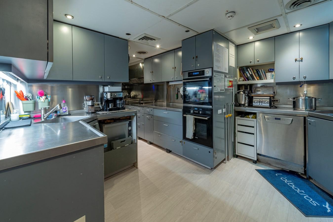 a kitchen with stainless steel appliances aboard L'ALBATROS Yacht for Sale