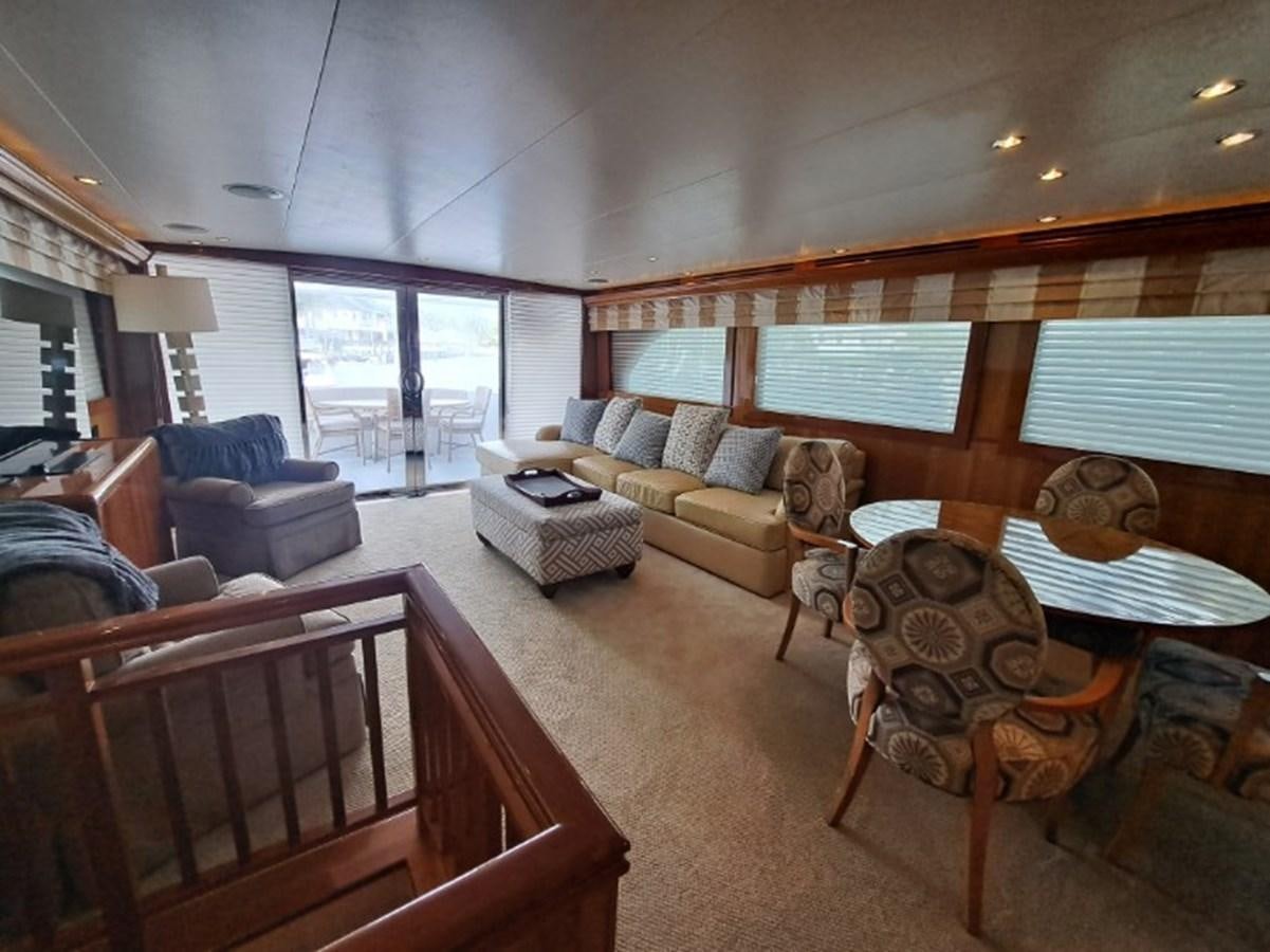 a living room with a large wood floor aboard SEACLUSION Yacht for Sale