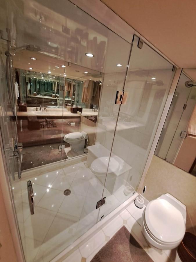 a bathroom with a glass shower aboard SEACLUSION Yacht for Sale