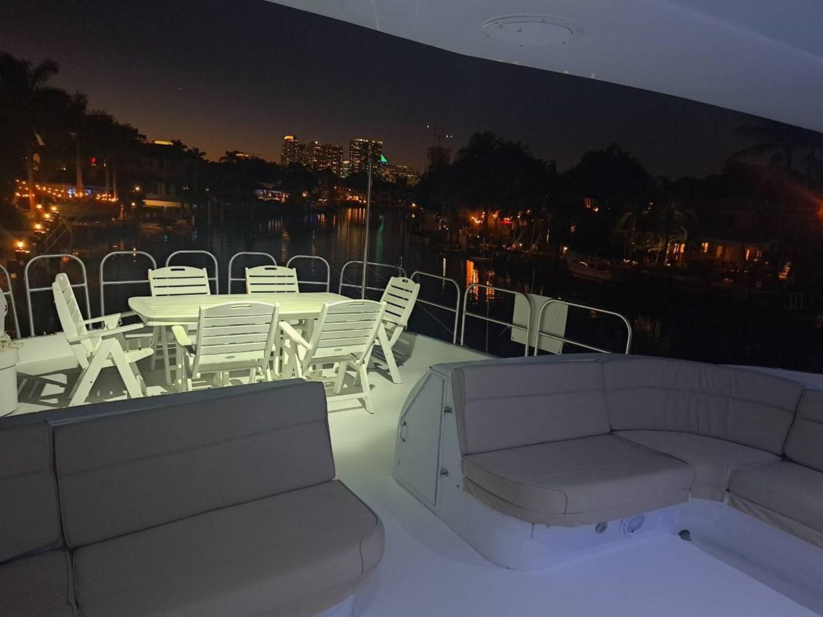 a patio with white chairs and tables aboard SEACLUSION Yacht for Sale