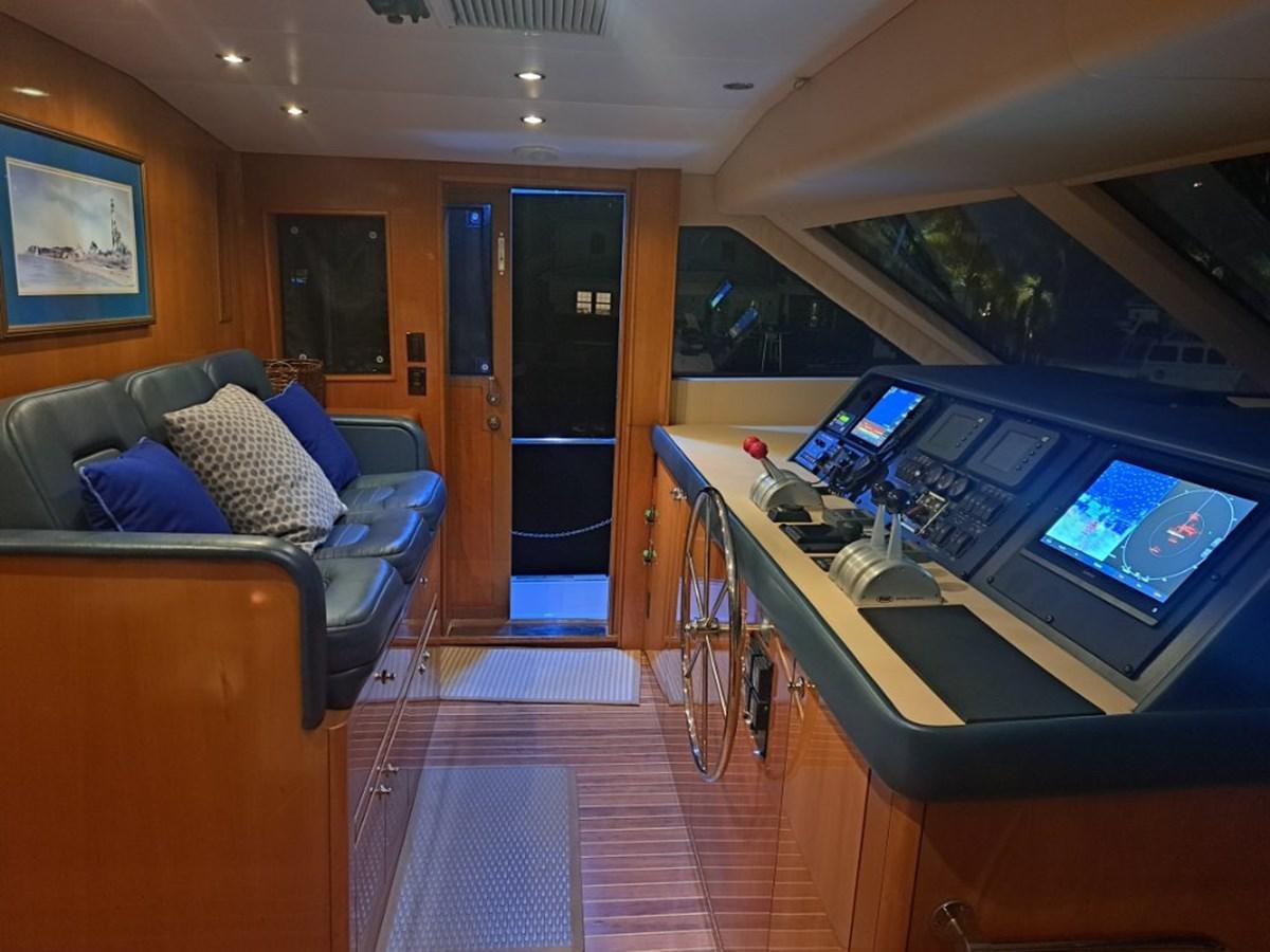 a room with a couch and a table with computers on it aboard SEACLUSION Yacht for Sale