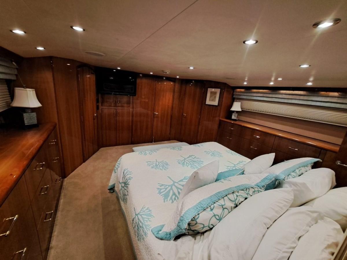 a bed with a blue comforter aboard SEACLUSION Yacht for Sale