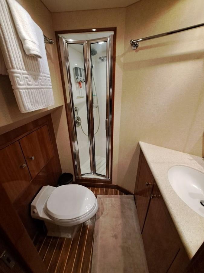 a bathroom with a toilet and a sink aboard SEACLUSION Yacht for Sale