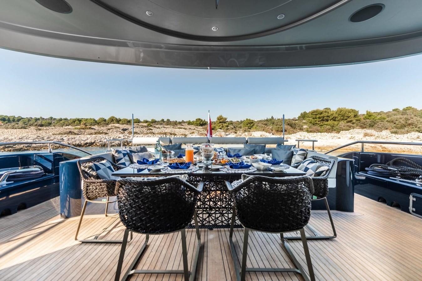 a table set up on a deck aboard ONE BLUE Yacht for Sale