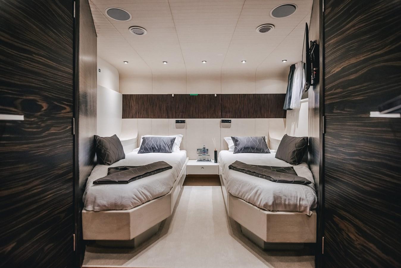 a room with a bed and a closet aboard ONE BLUE Yacht for Sale