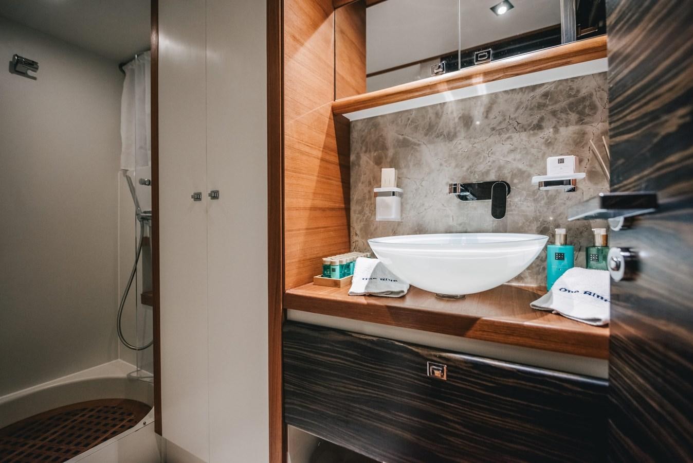 a bathroom with a sink and a mirror aboard ONE BLUE Yacht for Sale