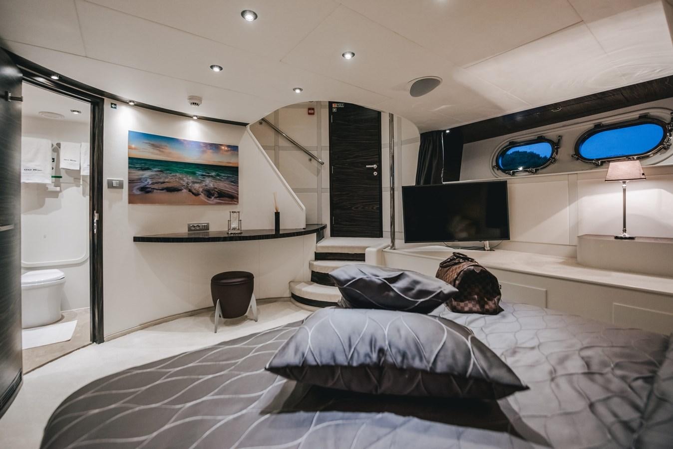 a room with a bed and a tv aboard ONE BLUE Yacht for Sale