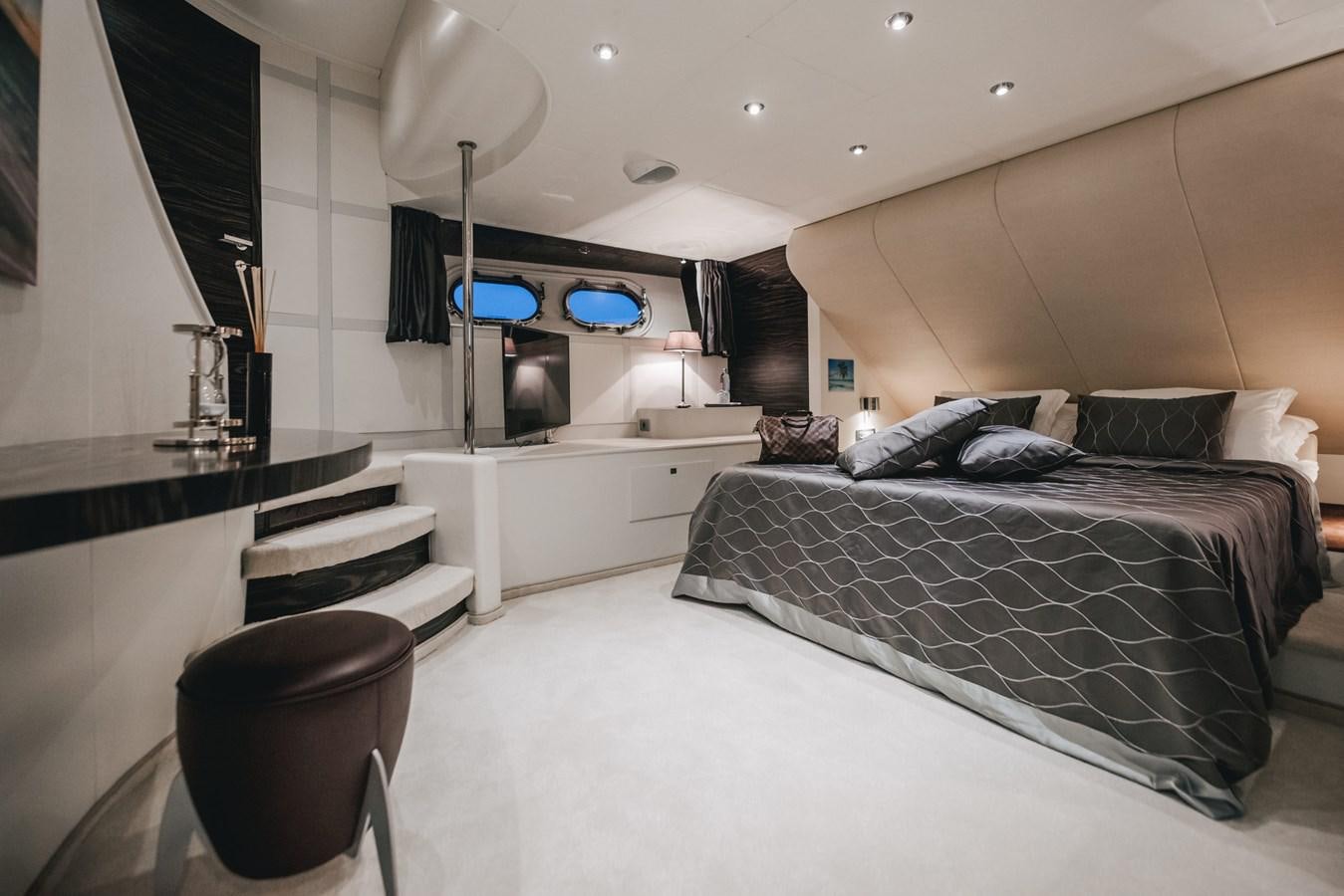 a bedroom with a bed and a tv aboard ONE BLUE Yacht for Sale