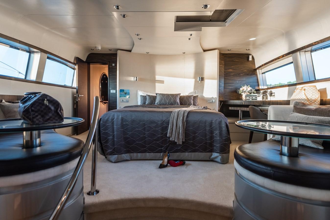 a bedroom with a bed and desk aboard ONE BLUE Yacht for Sale
