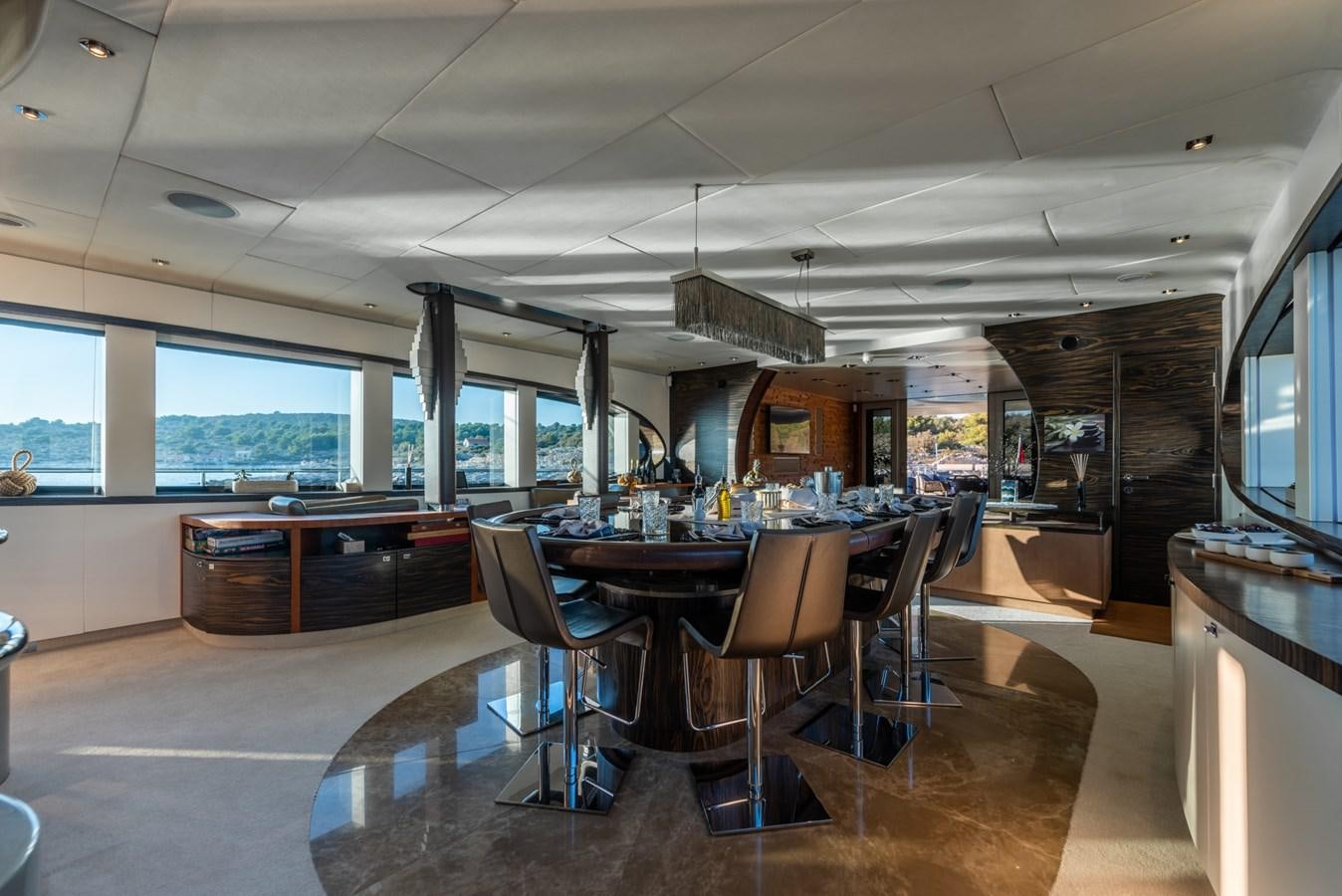 a room with tables and chairs aboard ONE BLUE Yacht for Sale