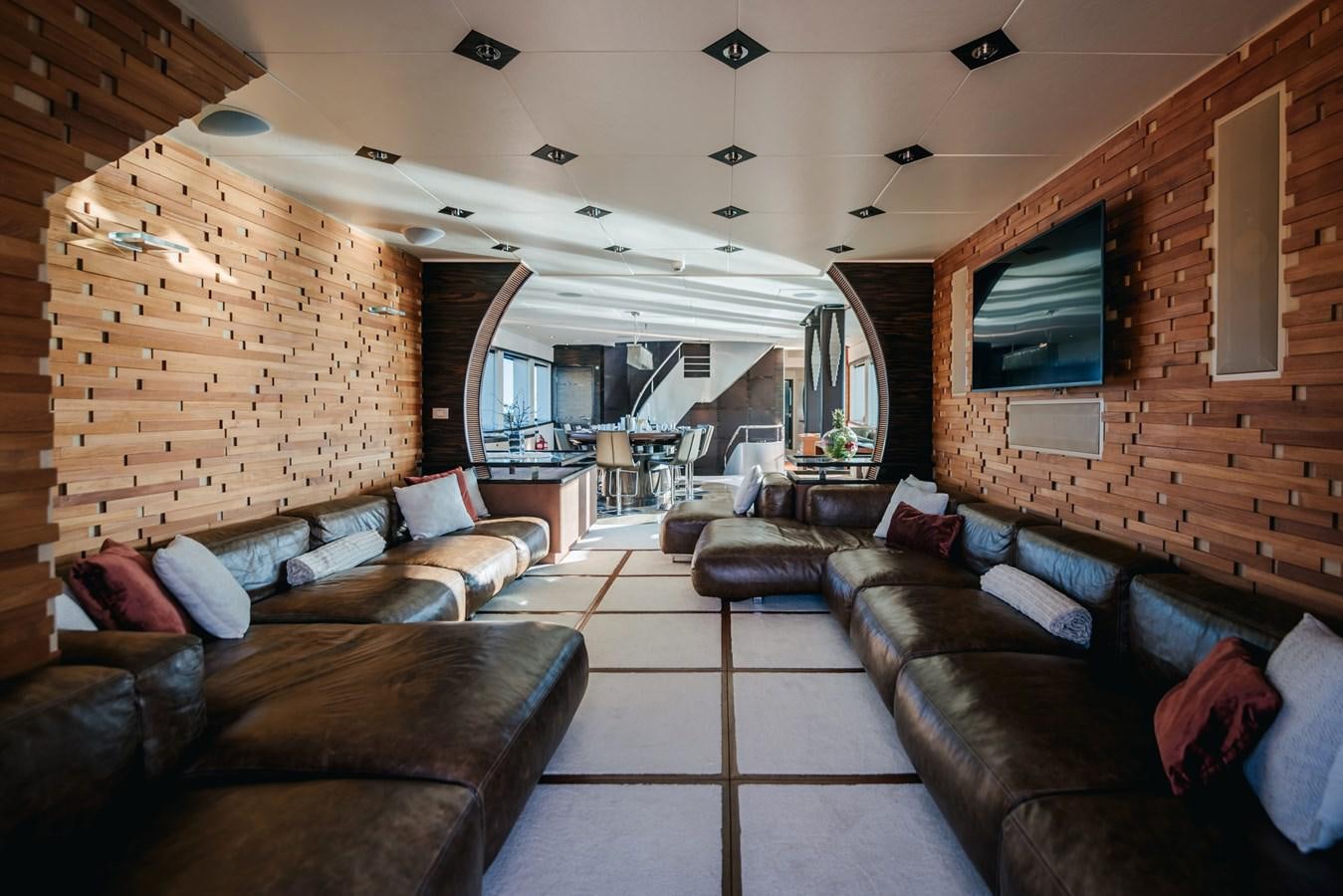a living room with leather couches aboard ONE BLUE Yacht for Sale