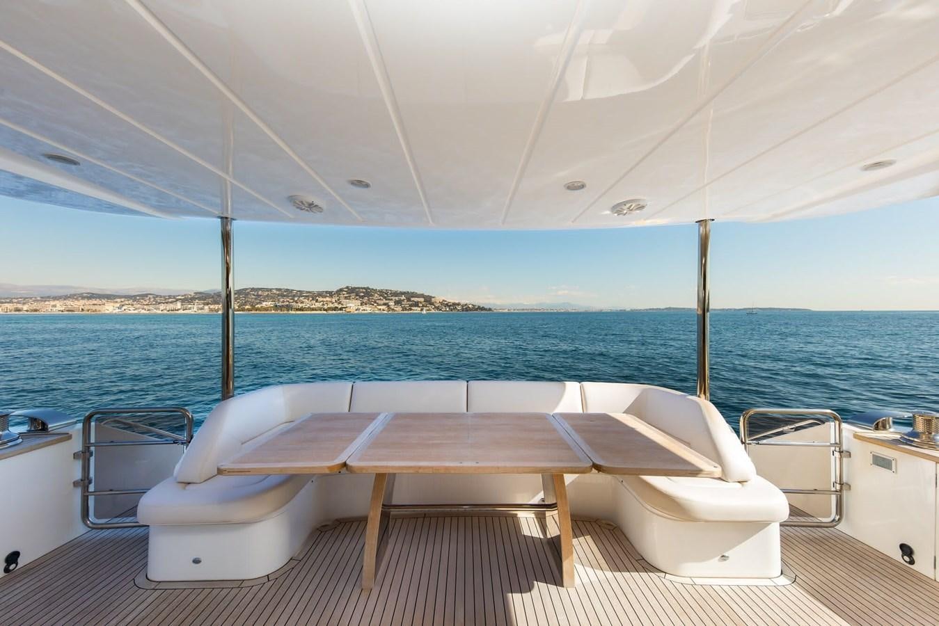 a table and chairs on a boat aboard 2009 PRINCESS 85 Yacht for Sale