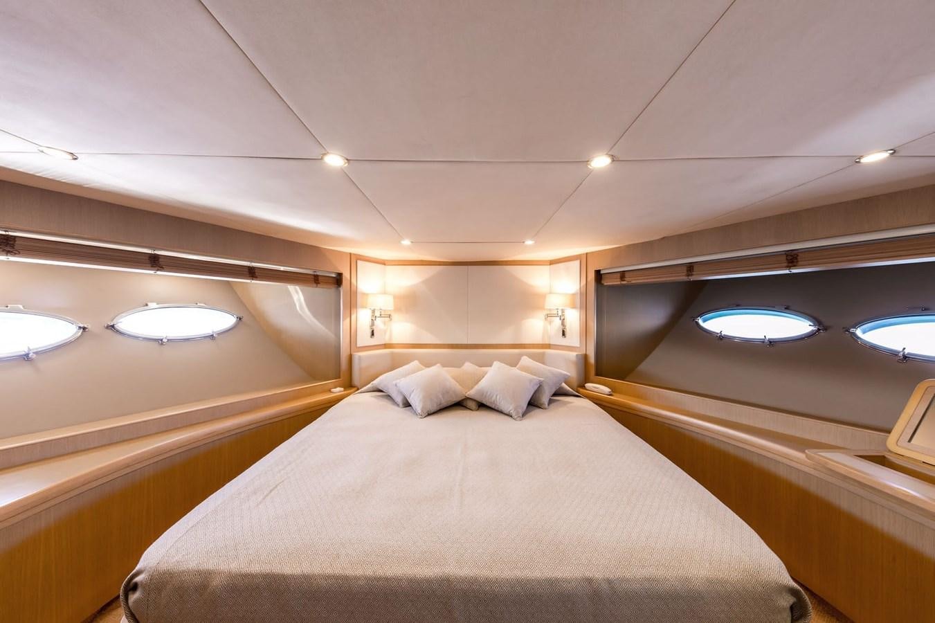 a room with a bed and a mirror aboard 2009 PRINCESS 85 Yacht for Sale