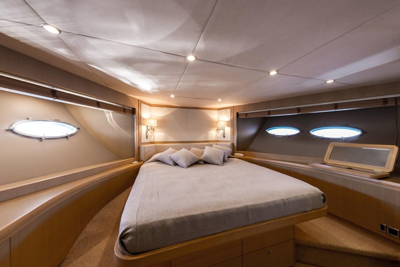 a room with a bed and a window aboard 2009 PRINCESS 85 Yacht for Sale