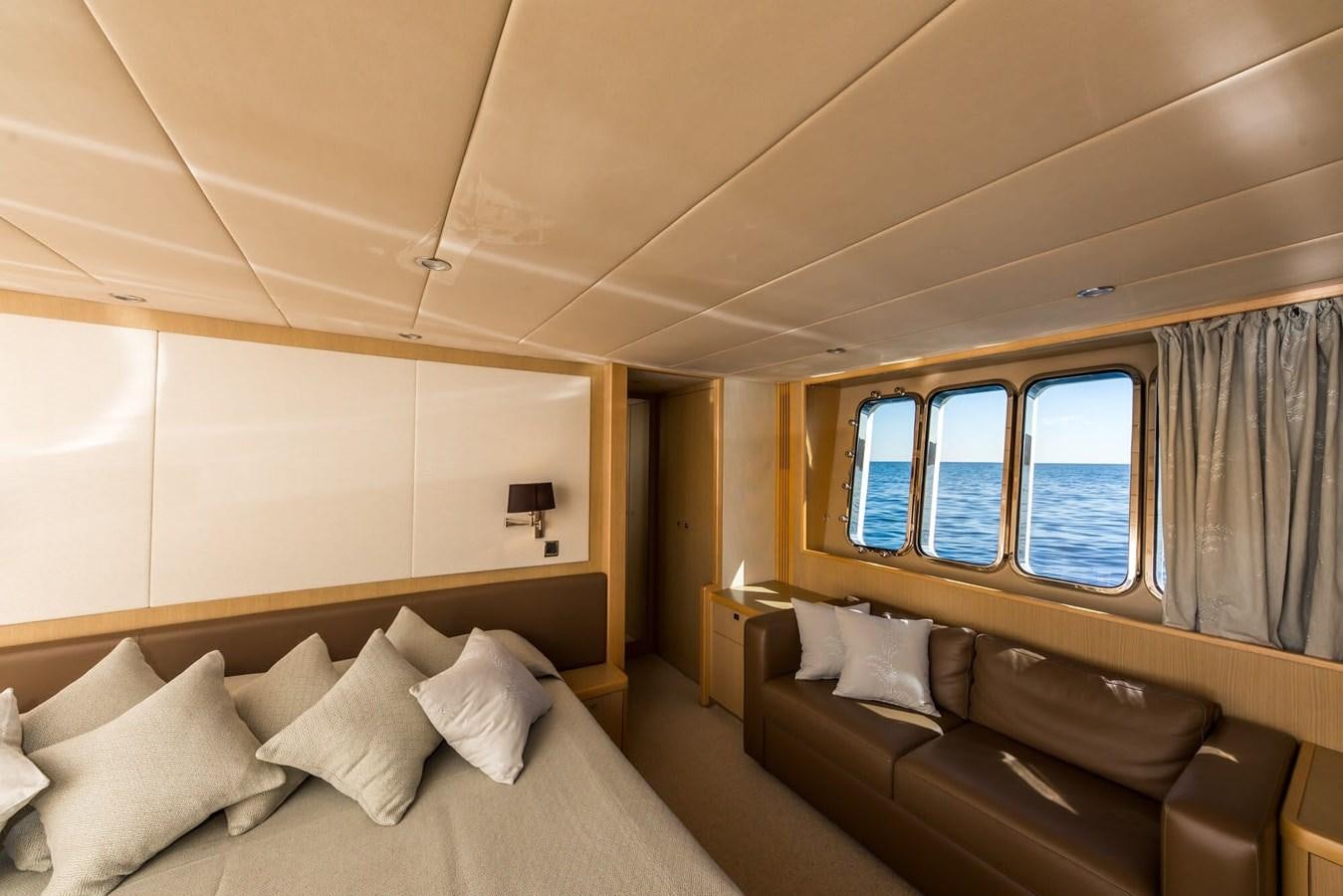 a room with a bed and a couch aboard 2009 PRINCESS 85 Yacht for Sale