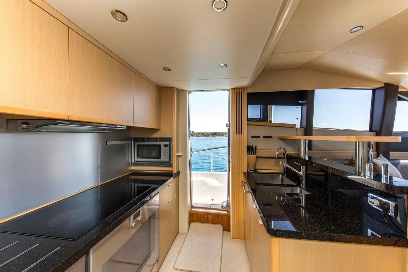 a kitchen with a large window aboard 2009 PRINCESS 85 Yacht for Sale