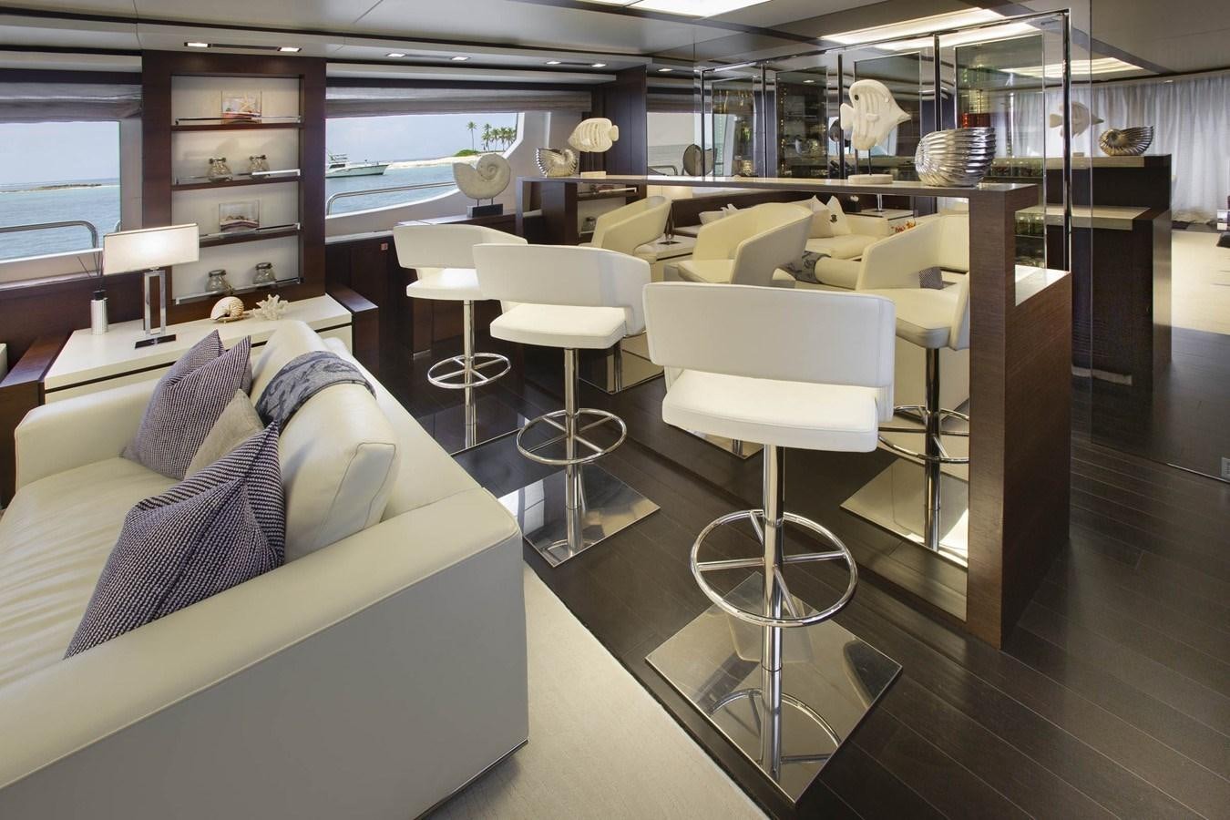 a room with a bed and a table aboard INSIEME Yacht for Sale