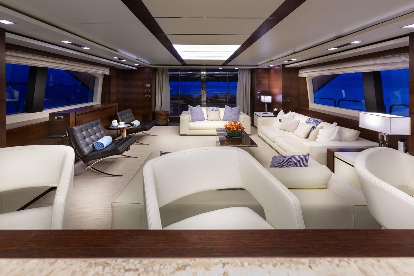 a room with a couch and a table and a television aboard INSIEME Yacht for Sale