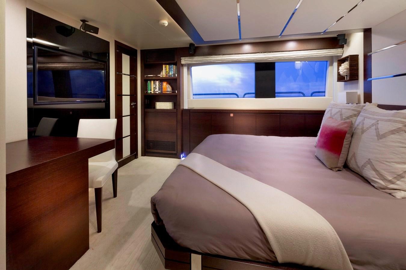 a room with a bed and a tv aboard INSIEME Yacht for Sale