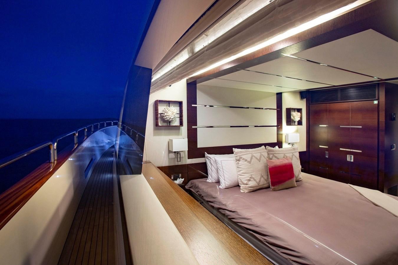 a room with a bed and a wood door aboard INSIEME Yacht for Sale