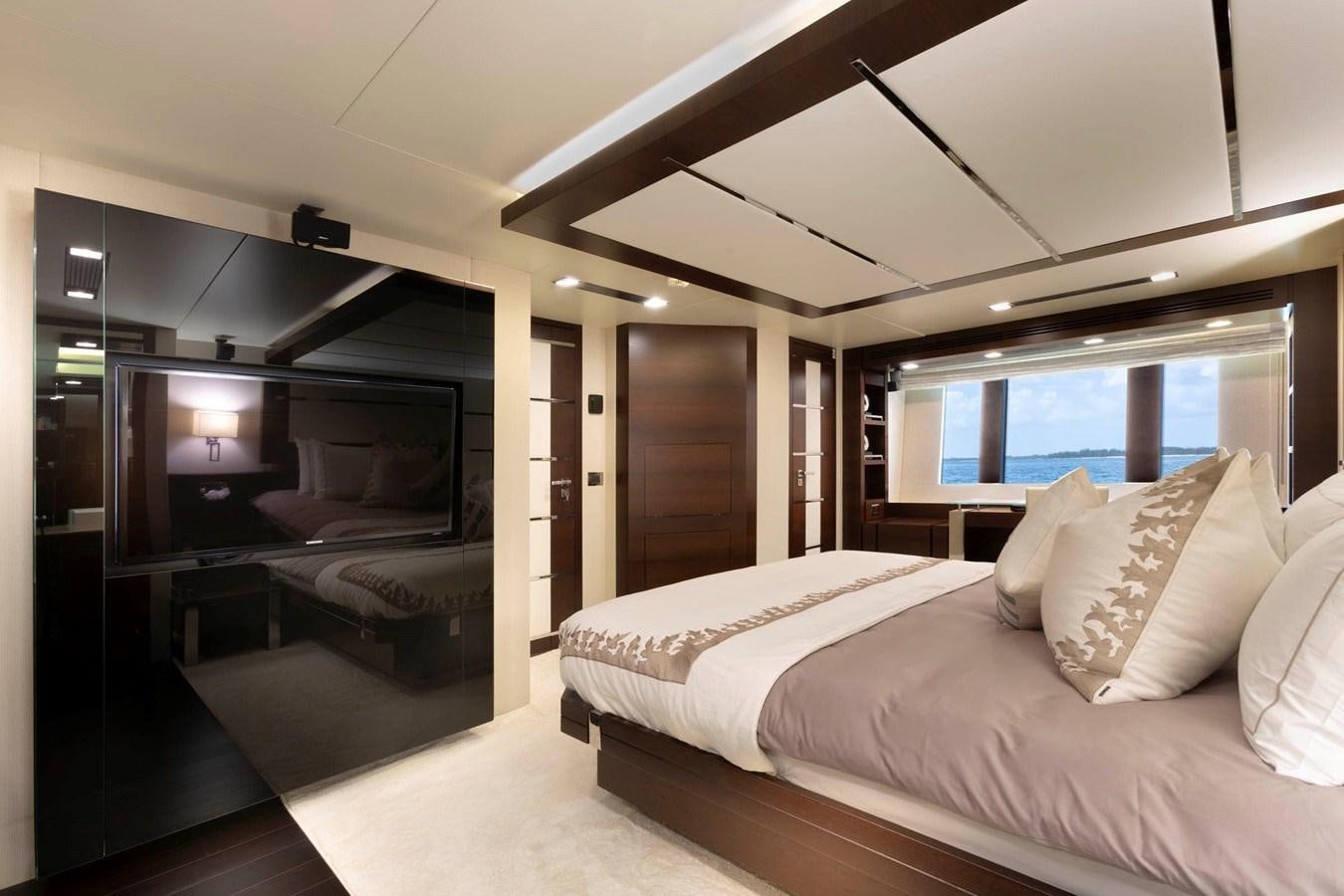 a room with a bed and a television aboard INSIEME Yacht for Sale