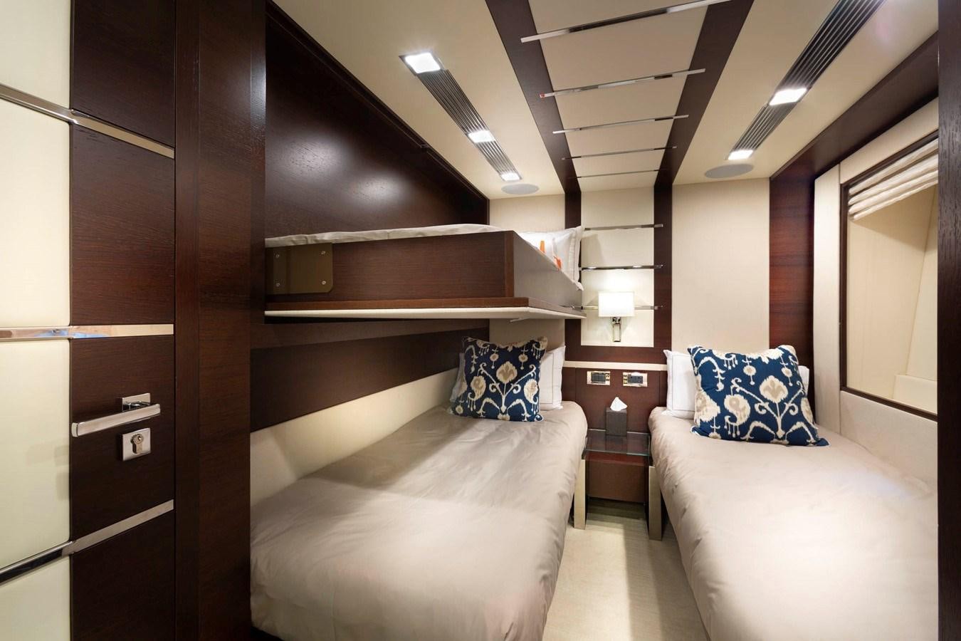 a room with a bed and a desk aboard INSIEME Yacht for Sale