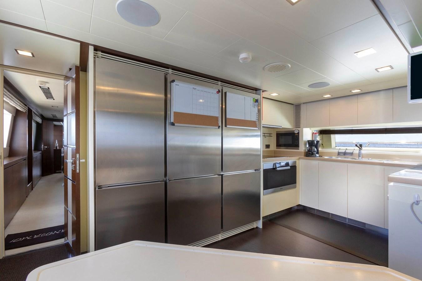 a large kitchen with stainless steel appliances aboard INSIEME Yacht for Sale