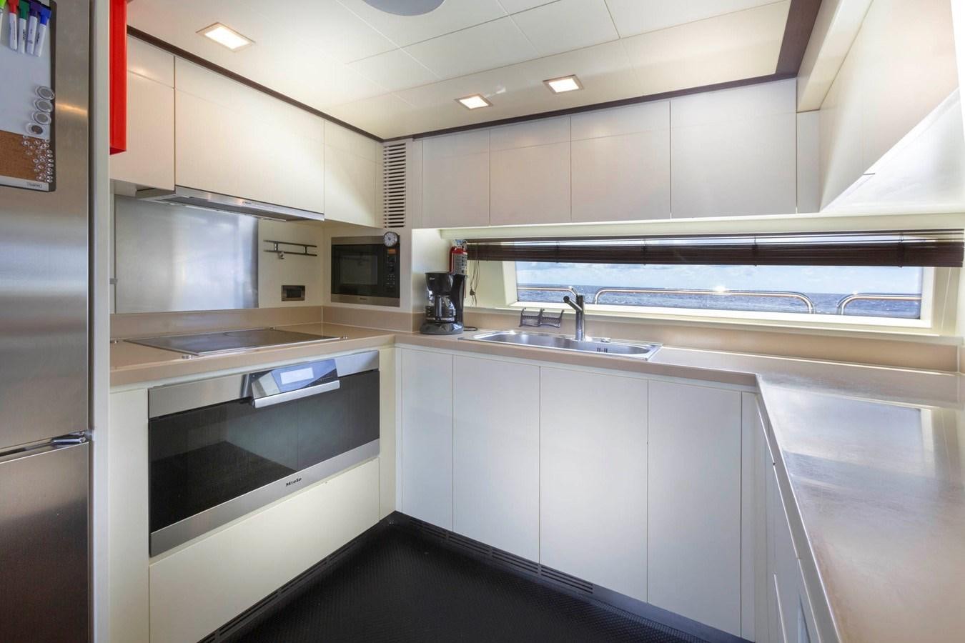 a kitchen with white cabinets aboard INSIEME Yacht for Sale