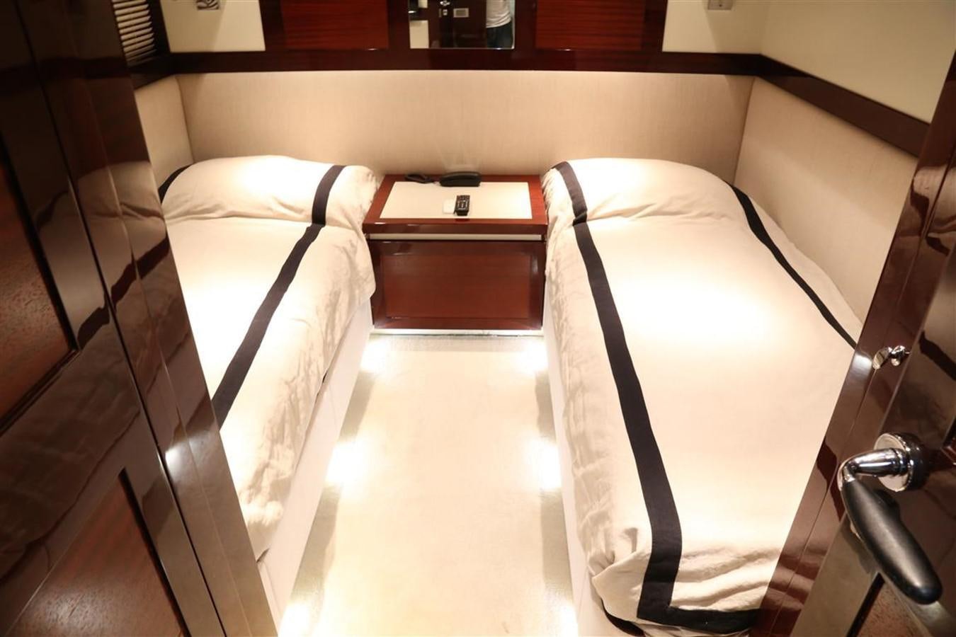 a bed with white sheets aboard AMER 86 Yacht for Sale