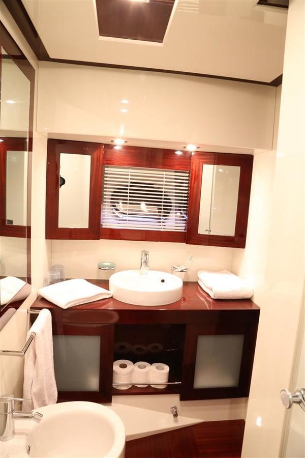 a bathroom with a mirror and sink aboard AMER 86 Yacht for Sale