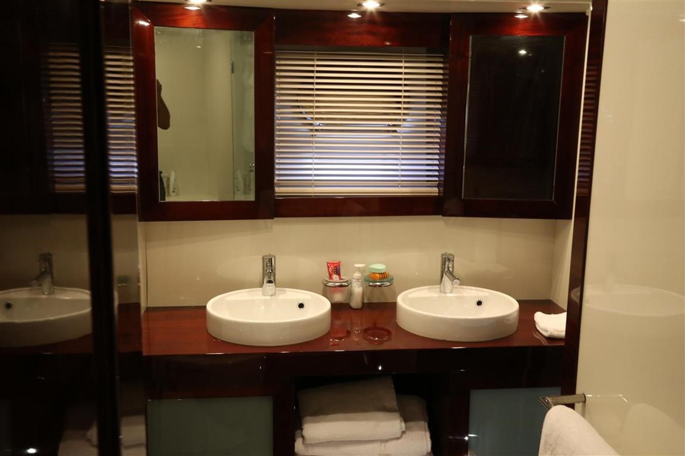a bathroom with two sinks and a mirror aboard AMER 86 Yacht for Sale