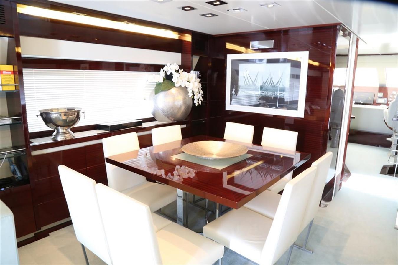 a room with a table and chairs aboard AMER 86 Yacht for Sale